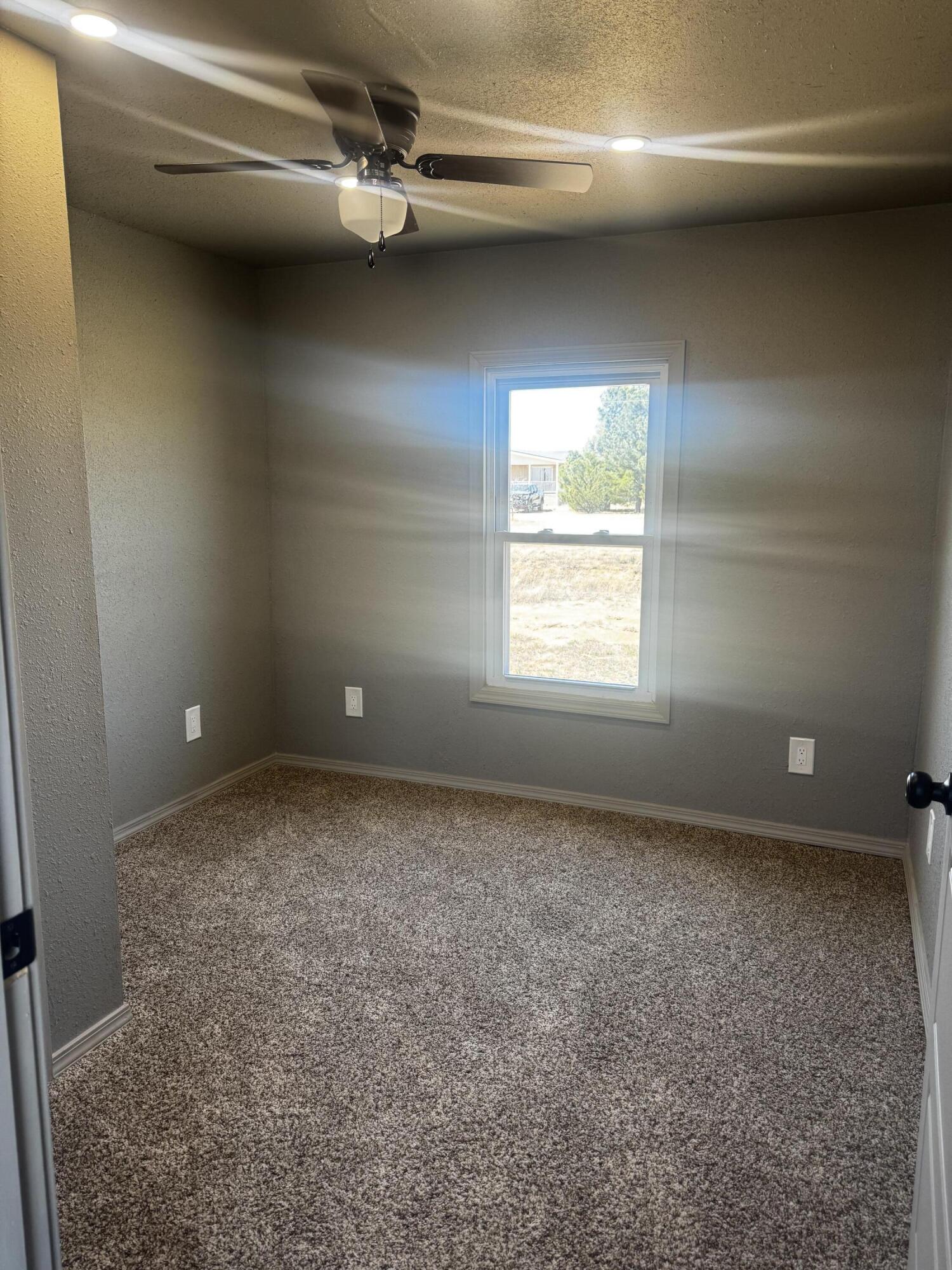 1128 Alaska Road Levelland, TX 79336 - Photo 14 of 20 a view of an empty room with a window