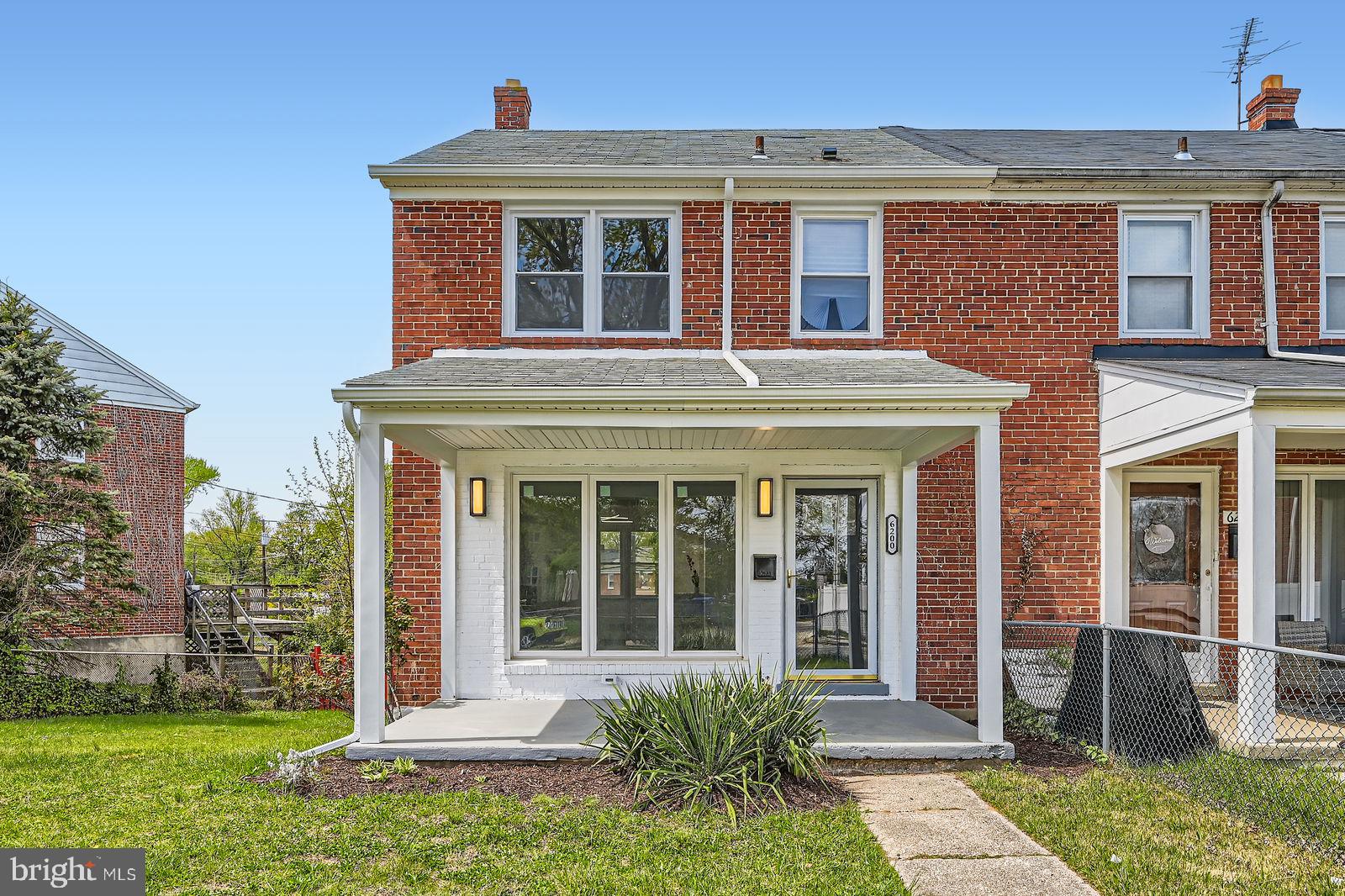 6200 Falkirk Road Baltimore, MD 21239 - Photo 1 of 27 front view of a brick house with a yard
