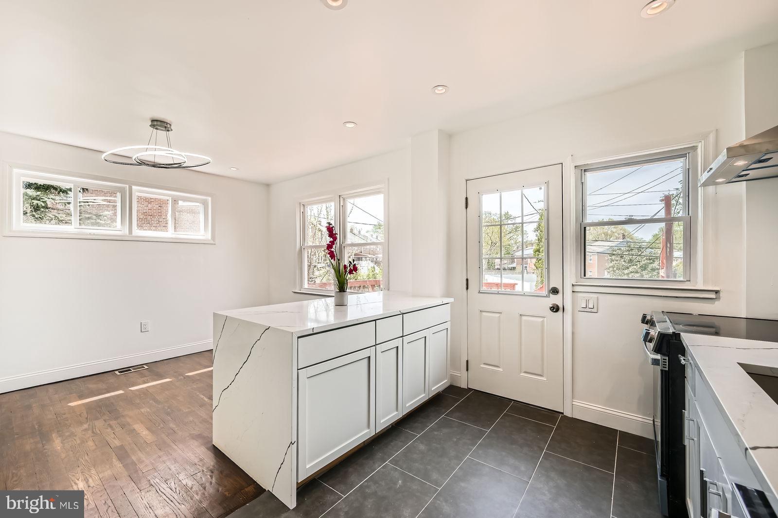 6200 Falkirk Road Baltimore, MD 21239 - Photo 12 of 27 a view of a kitchen with cabinets and wooden floor