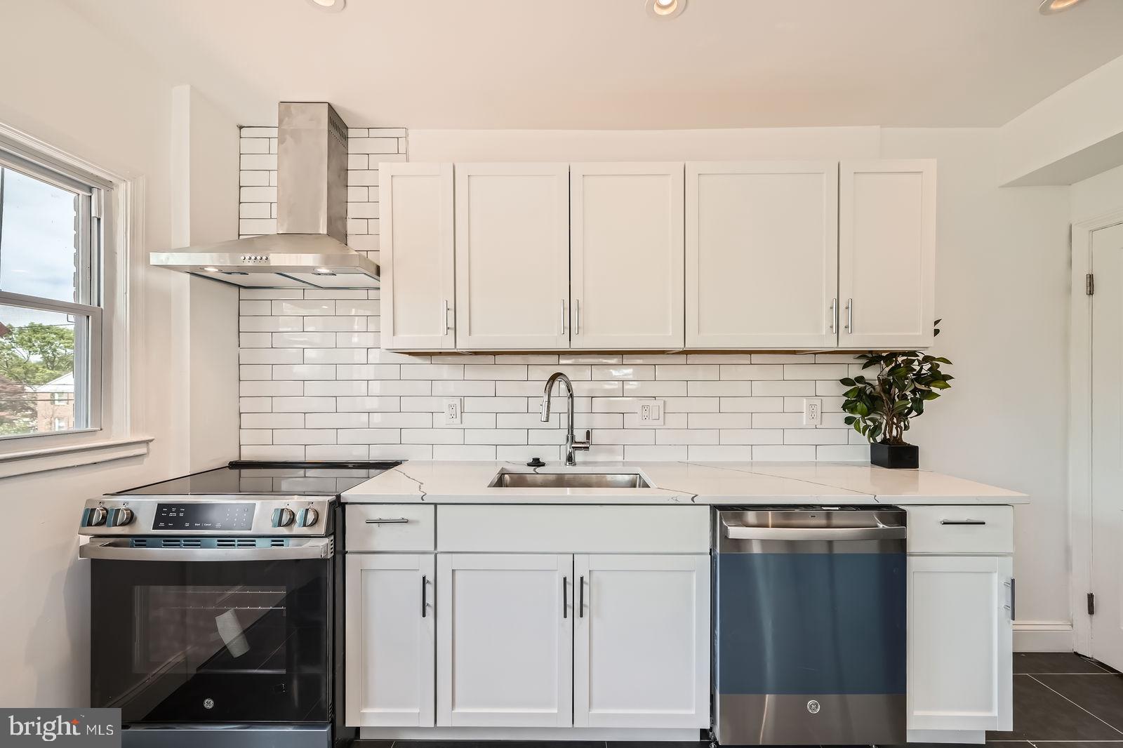 6200 Falkirk Road Baltimore, MD 21239 - Photo 13 of 27 a kitchen with stainless steel appliances granite countertop a sink stove and cabinets