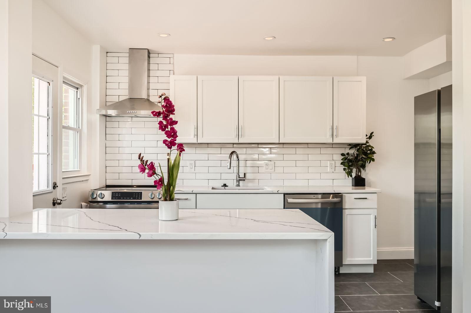 6200 Falkirk Road Baltimore, MD 21239 - Photo 15 of 27 a kitchen with a sink cabinets and window