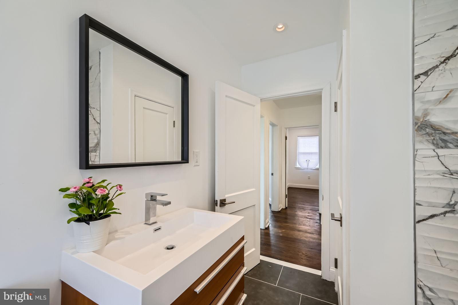 6200 Falkirk Road Baltimore, MD 21239 - Photo 18 of 27 a bathroom with a sink and a mirror