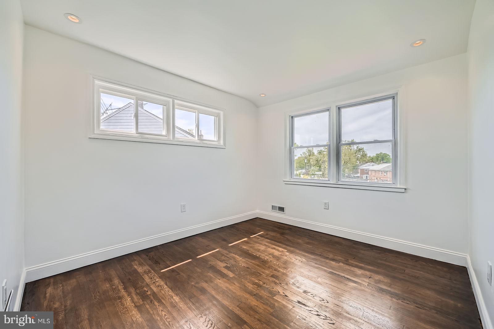 6200 Falkirk Road Baltimore, MD 21239 - Photo 20 of 27 an empty room with wooden floor and windows