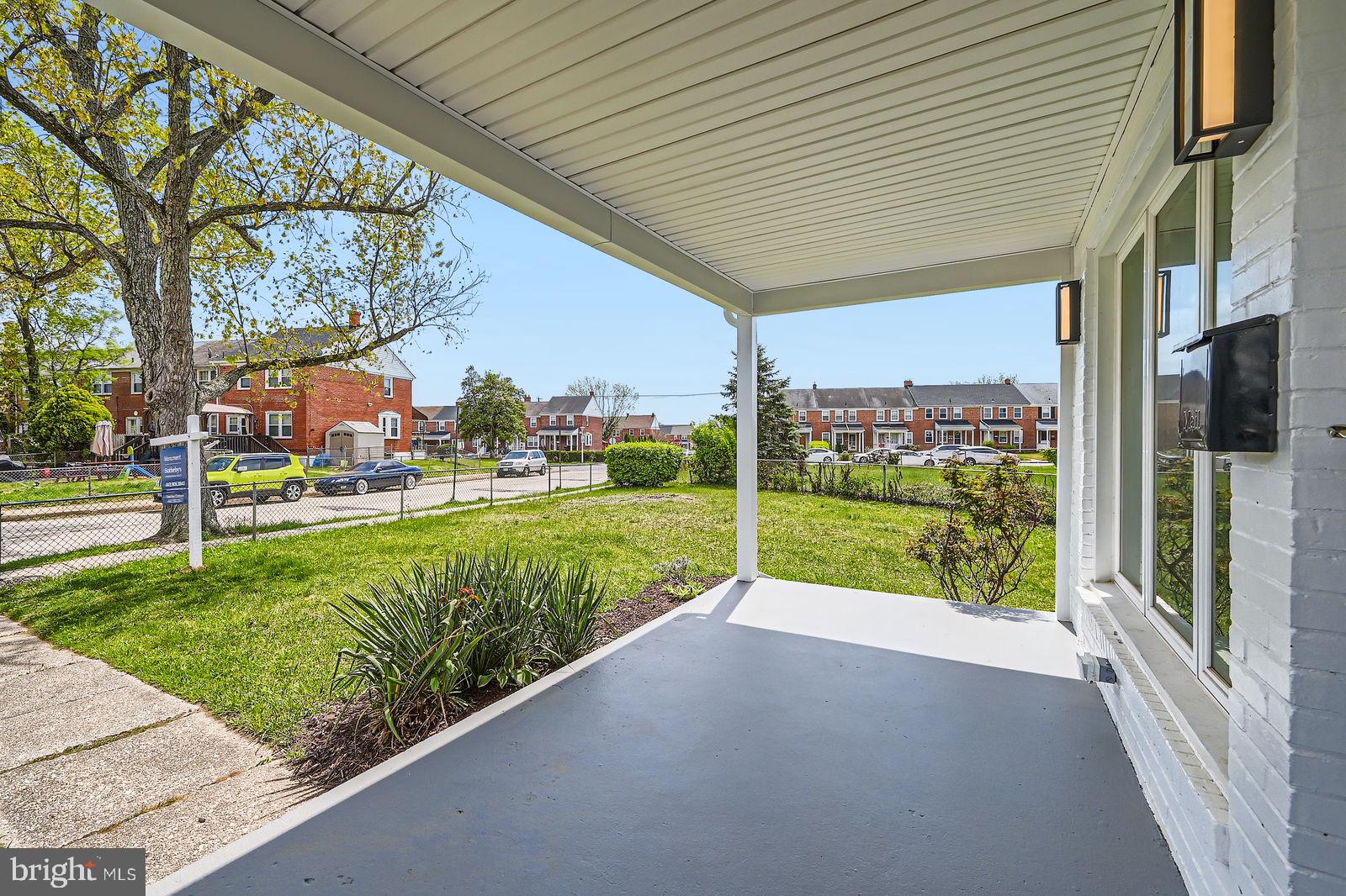 6200 Falkirk Road Baltimore, MD 21239 - Photo 3 of 27 a view of a house with a big yard and potted plants