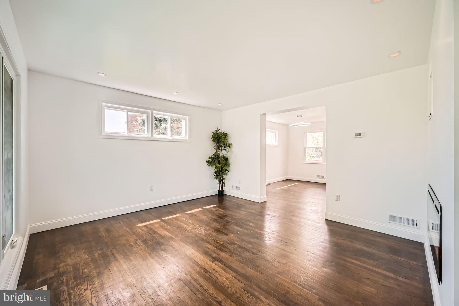 6200 Falkirk Road Baltimore, MD 21239 - Photo 4 of 27 a view of a big room with wooden floor and windows