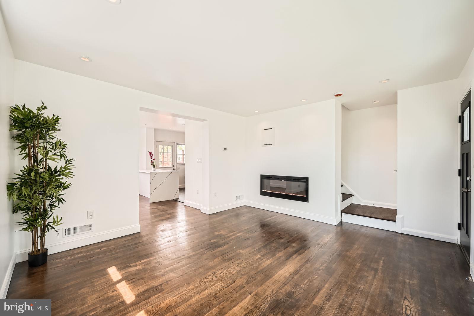6200 Falkirk Road Baltimore, MD 21239 - Photo 5 of 27 a view of a room with wooden floor and potted plants