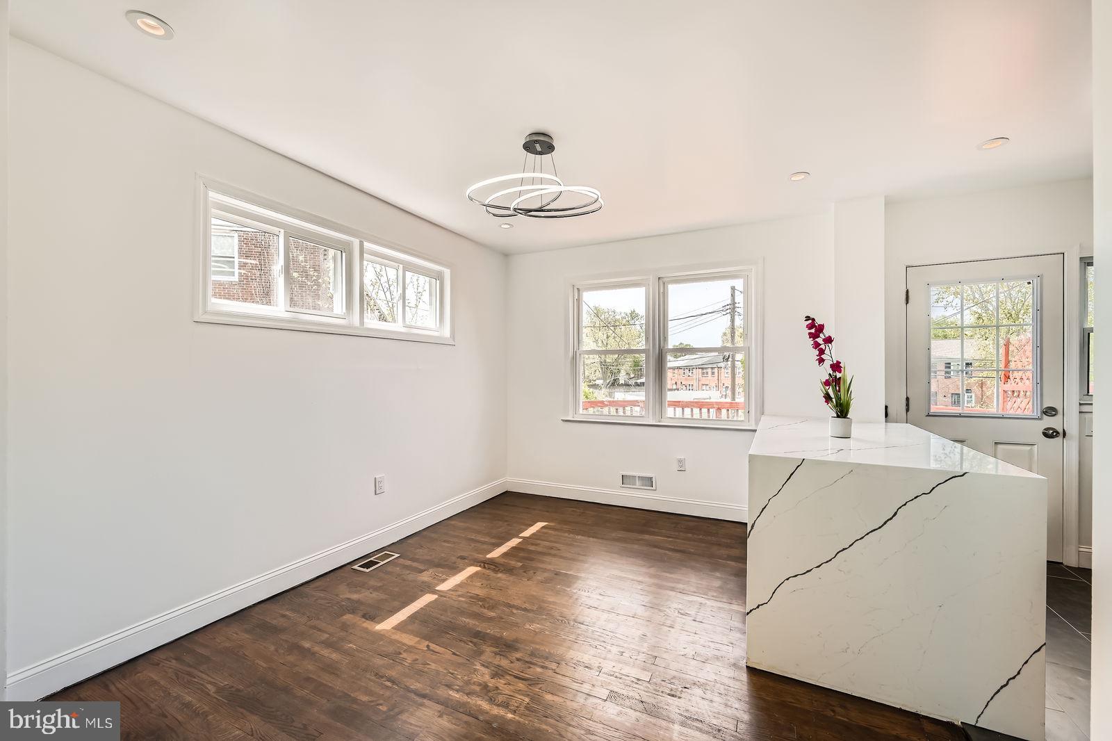6200 Falkirk Road Baltimore, MD 21239 - Photo 7 of 27 a view of a livingroom with wooden floor and a large window