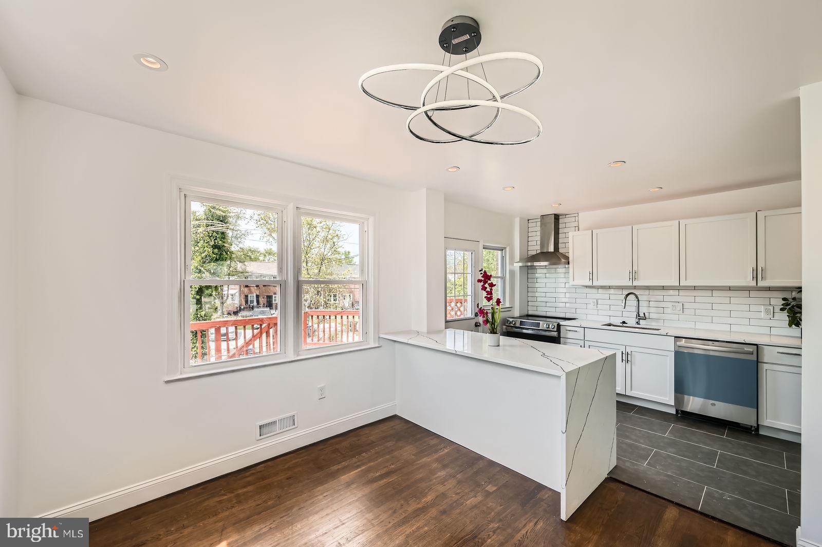 6200 Falkirk Road Baltimore, MD 21239 - Photo 8 of 27 a kitchen with a stove cabinets and window