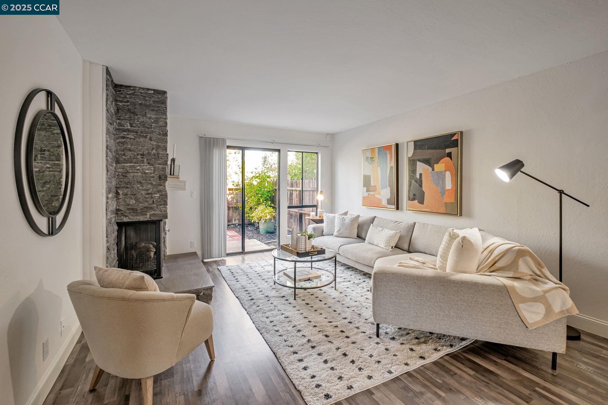 849 Tampico Walnut Creek, CA 94598 - Photo 3 of 24 a living room with furniture a fireplace and a table