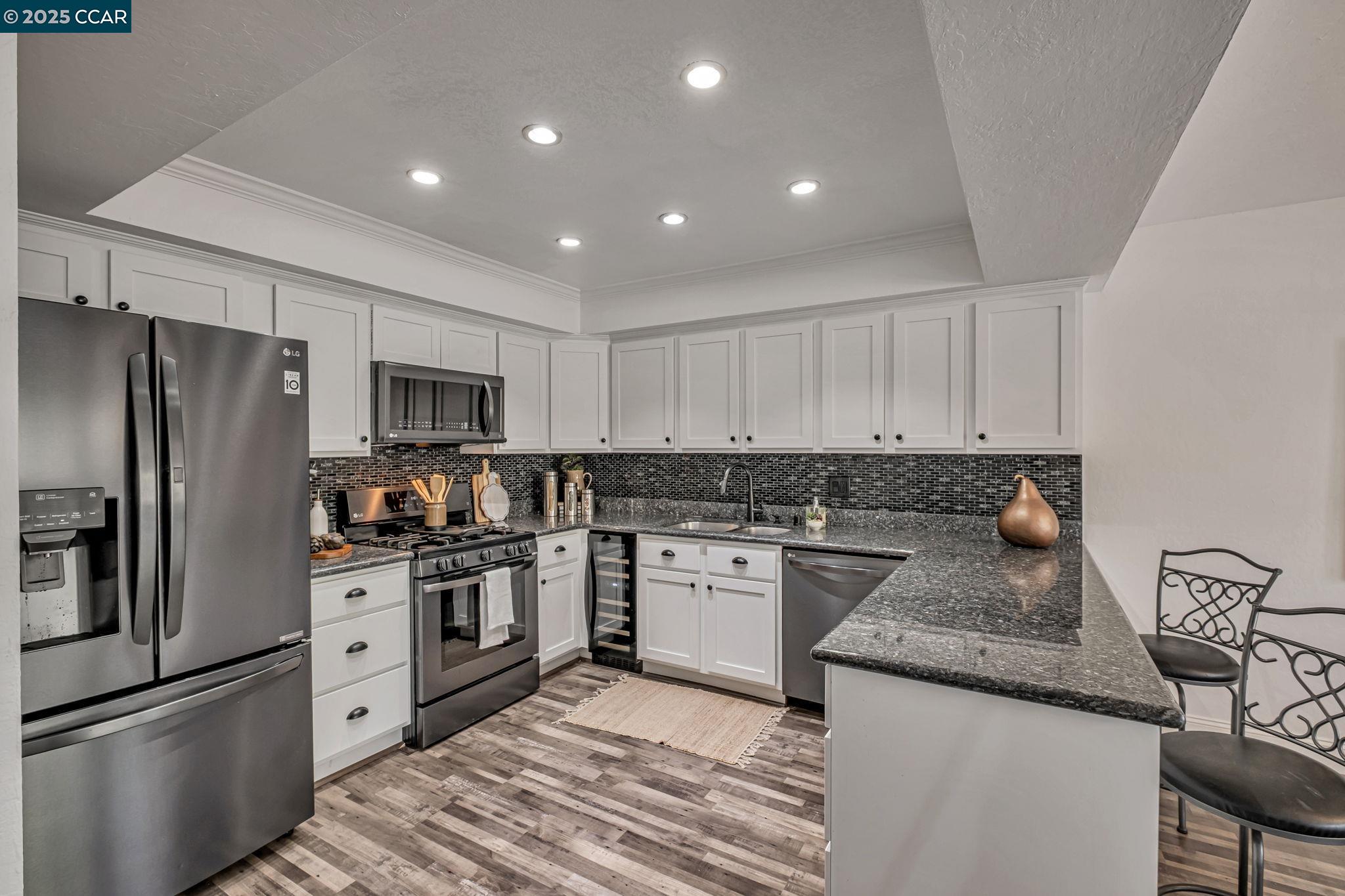 849 Tampico Walnut Creek, CA 94598 - Photo 6 of 24 a kitchen with granite countertop stainless steel appliances and wooden cabinets