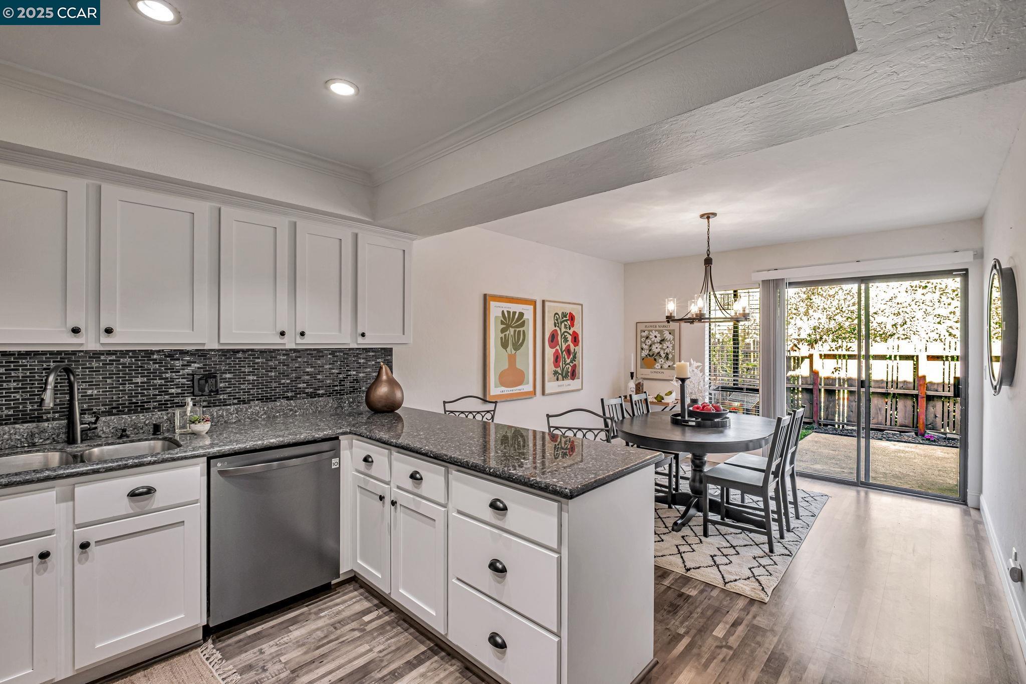 849 Tampico Walnut Creek, CA 94598 - Photo 7 of 24 a kitchen with white cabinets and wooden floor