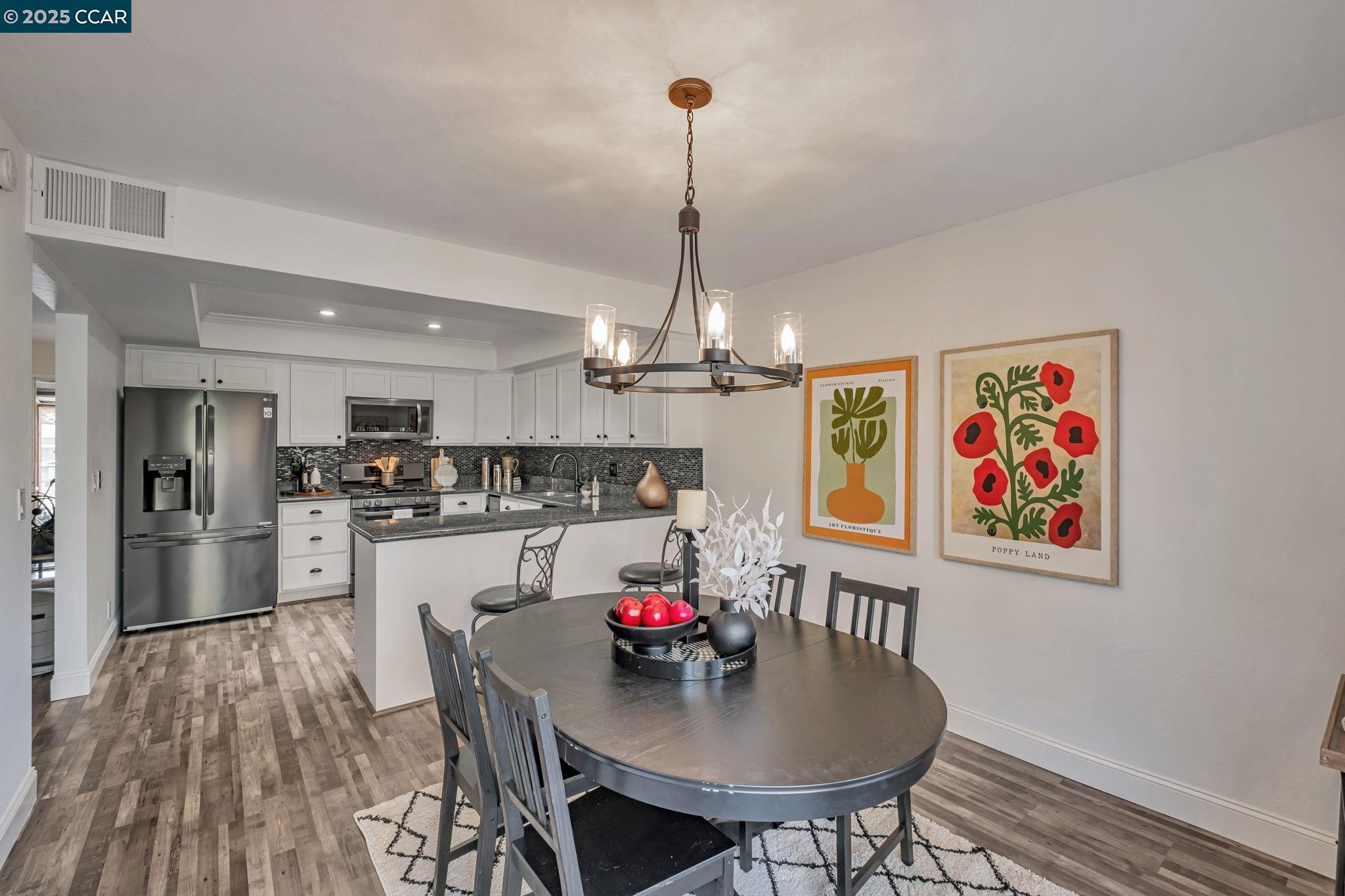 849 Tampico Walnut Creek, CA 94598 - Photo 8 of 24 a living room with stainless steel appliances furniture a dining table and a chandelier