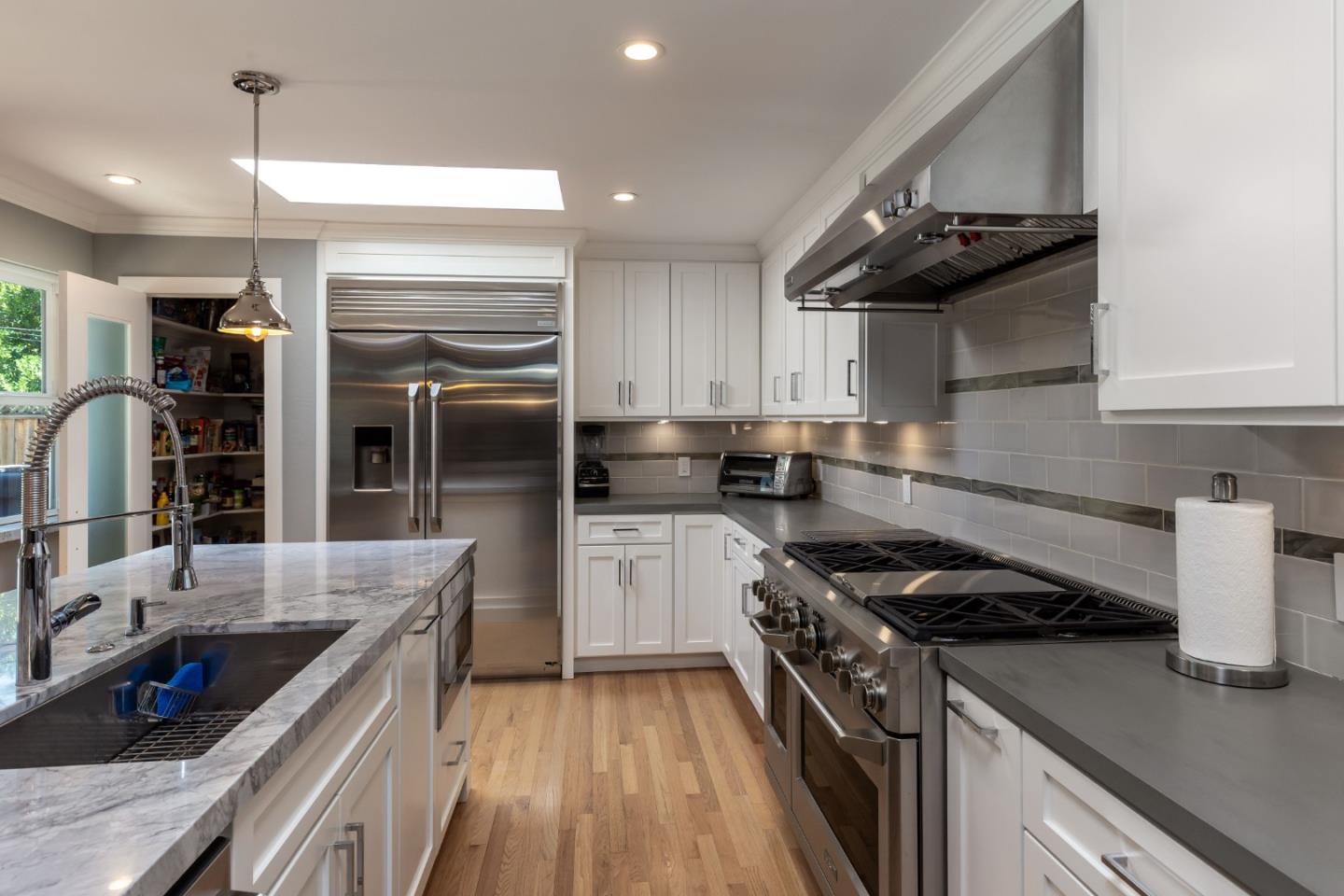 915 Cherrystone Drive Los Gatos, CA 95032 - Photo 11 of 37 a kitchen with granite countertop stainless steel appliances and wooden cabinets