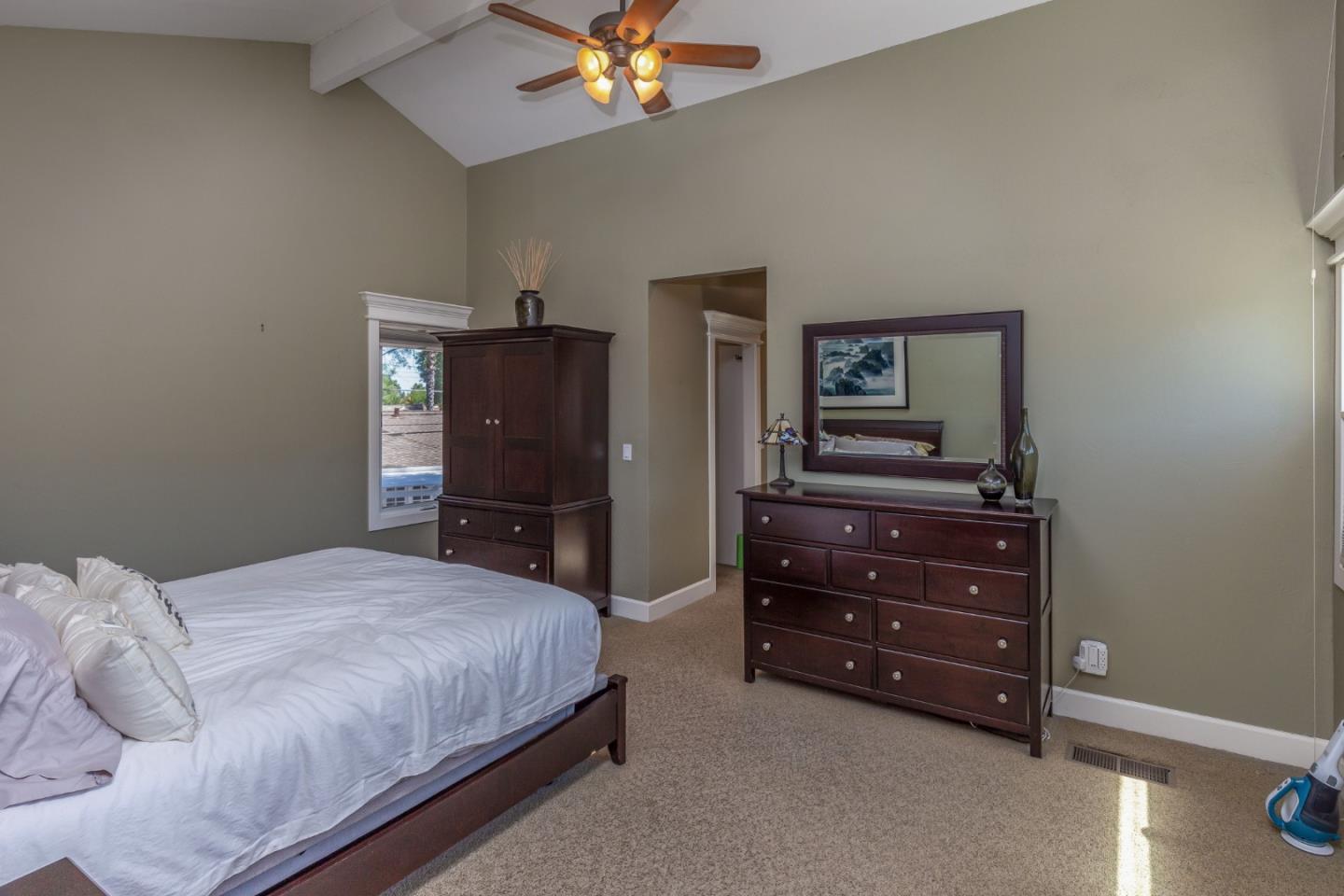 915 Cherrystone Drive Los Gatos, CA 95032 - Photo 17 of 37 a bedroom with a bed and a dresser