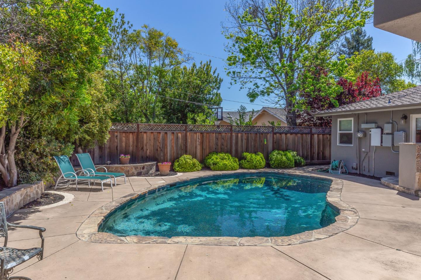 915 Cherrystone Drive Los Gatos, CA 95032 - Photo 31 of 37 a backyard with table and chairs and wooden fence