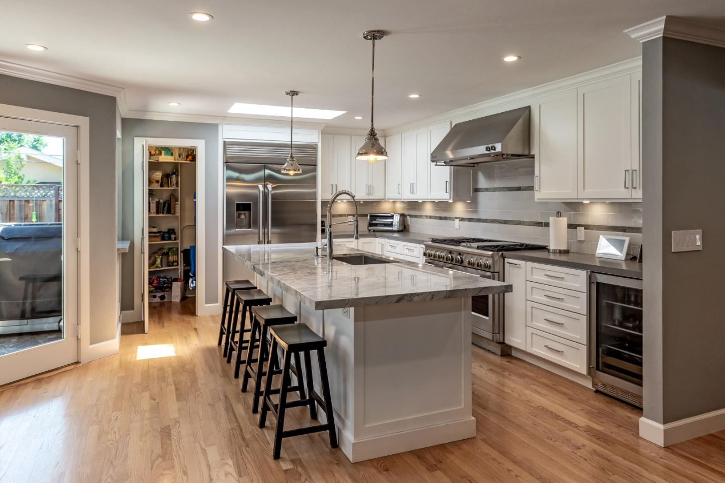 915 Cherrystone Drive Los Gatos, CA 95032 - Photo 10 of 37 a kitchen with kitchen island a large counter top space appliances and wooden floor