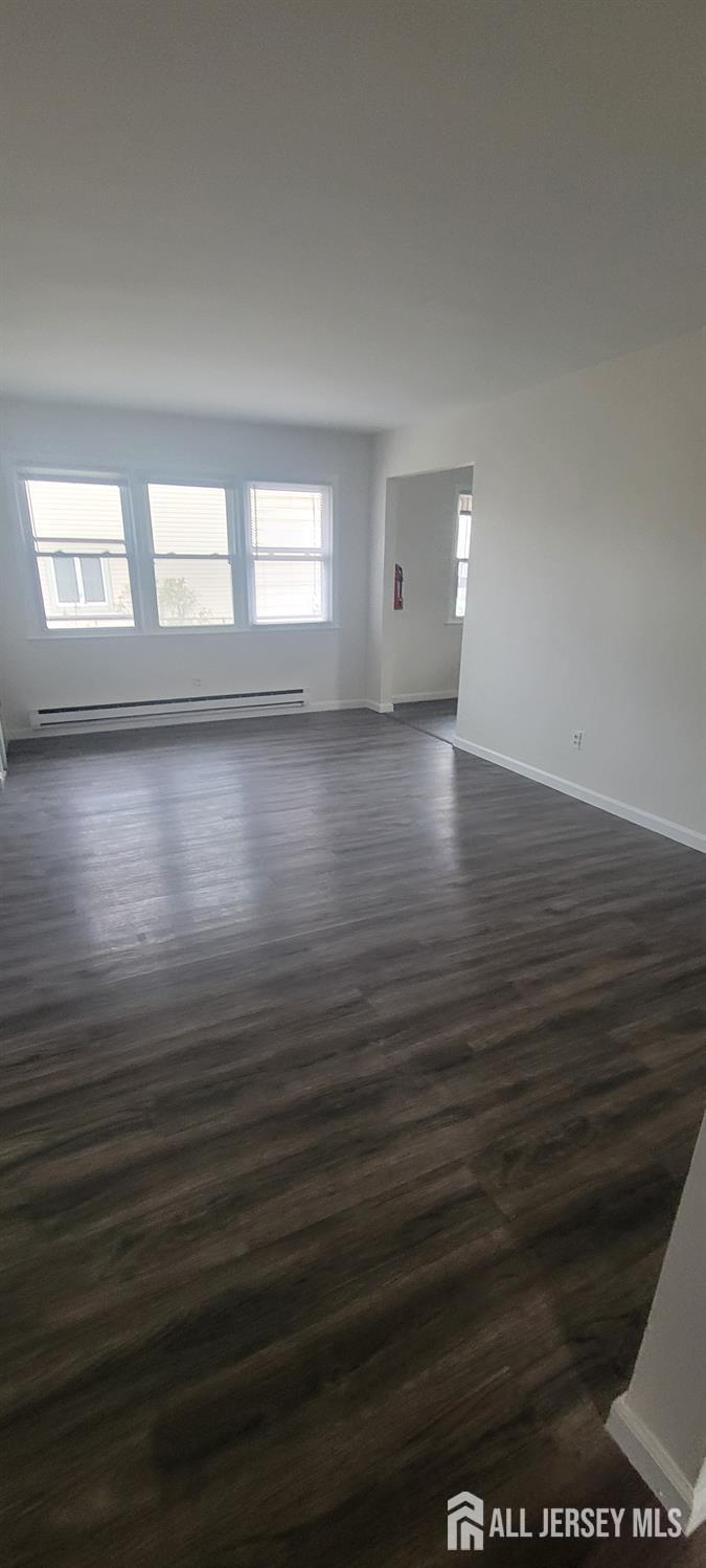 358 Raritan Street, Unit F South Amboy, NJ 08879 - Photo 3 of 5 an empty room with wooden floor and windows