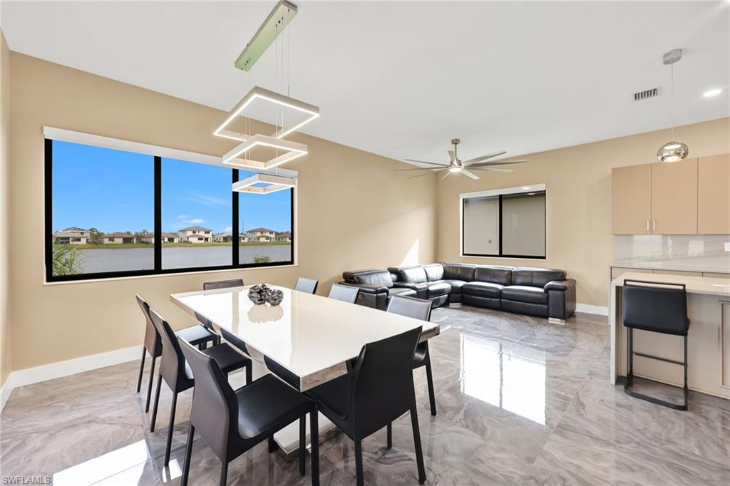 5074 Panella Avenue Immokalee, FL 34142 - Photo 11 of 48 a view of a dining room with furniture and wooden floor