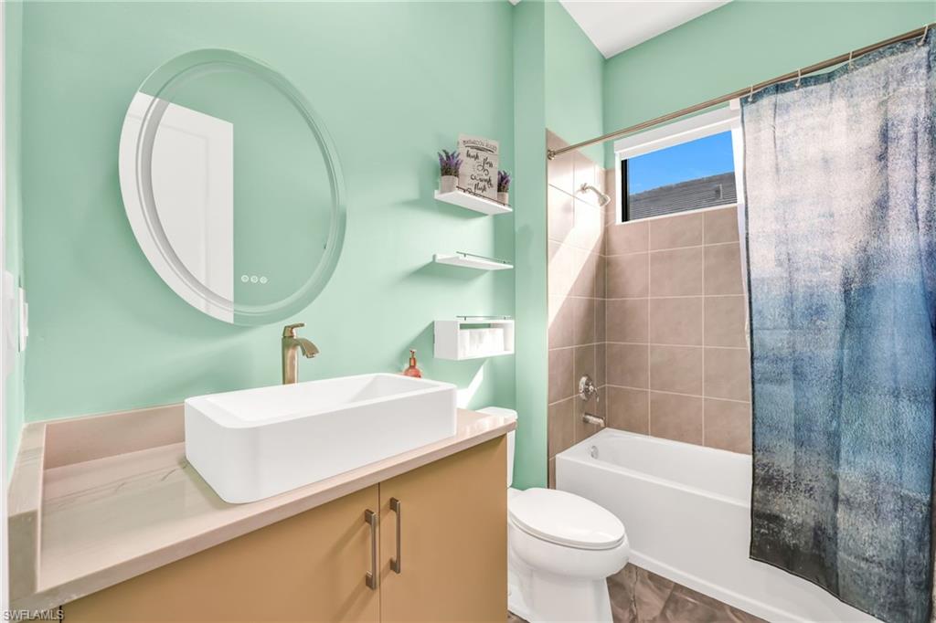 5074 Panella Avenue Immokalee, FL 34142 - Photo 13 of 48 a bathroom with a sink and a mirror