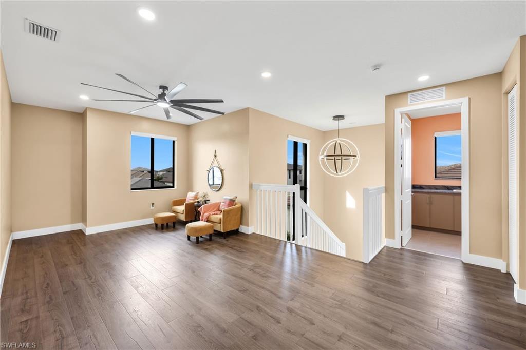 5074 Panella Avenue Immokalee, FL 34142 - Photo 15 of 48 a living room with furniture and wooden floor