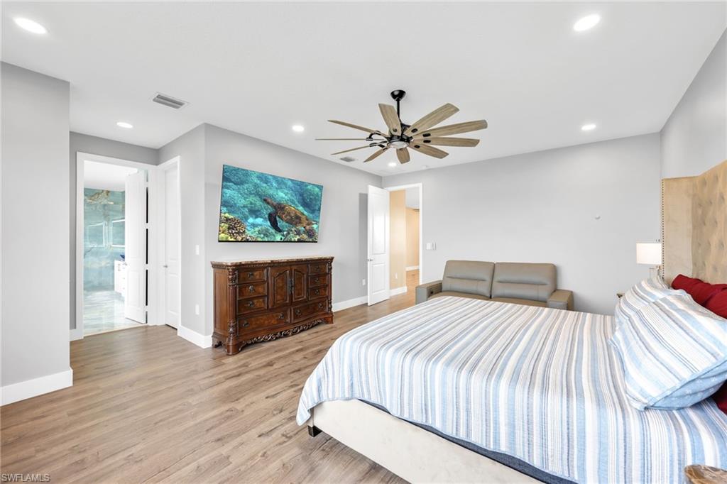 5074 Panella Avenue Immokalee, FL 34142 - Photo 17 of 48 a bedroom with a bed and a chandelier