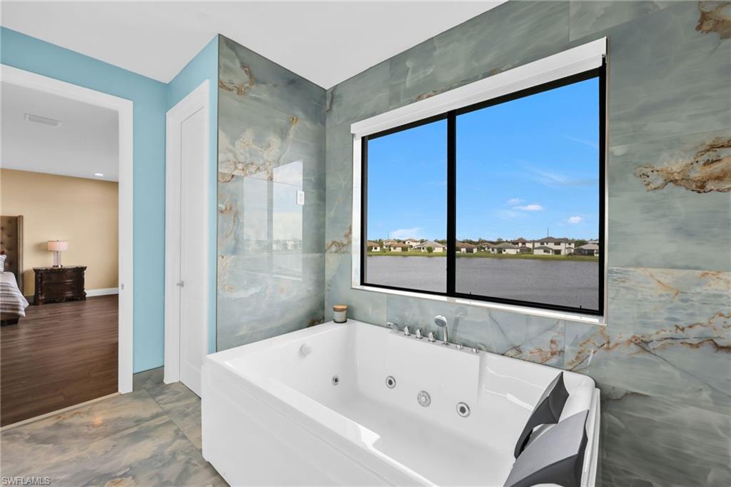 5074 Panella Avenue Immokalee, FL 34142 - Photo 20 of 48 a bathroom with a bathtub and a shower