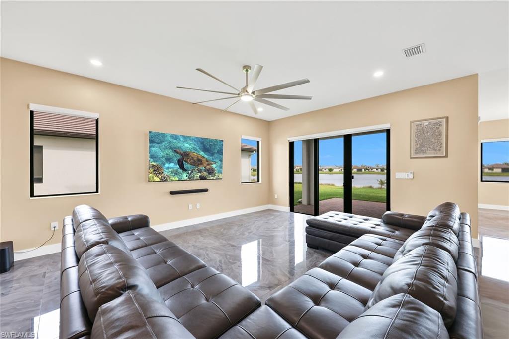 5074 Panella Avenue Immokalee, FL 34142 - Photo 3 of 48 a living room with furniture ceiling fan and a large window