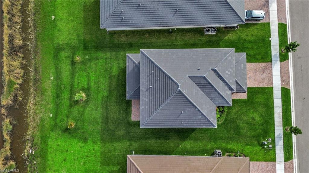 5074 Panella Avenue Immokalee, FL 34142 - Photo 36 of 48 a view of a house with a yard