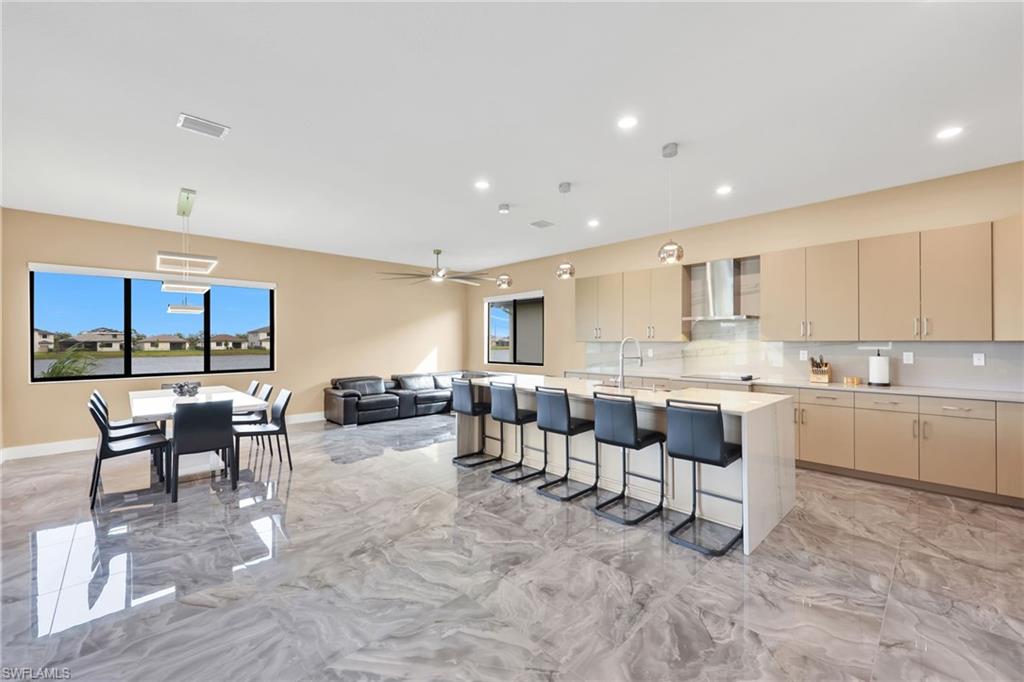 5074 Panella Avenue Immokalee, FL 34142 - Photo 5 of 48 a large white kitchen with table and chairs