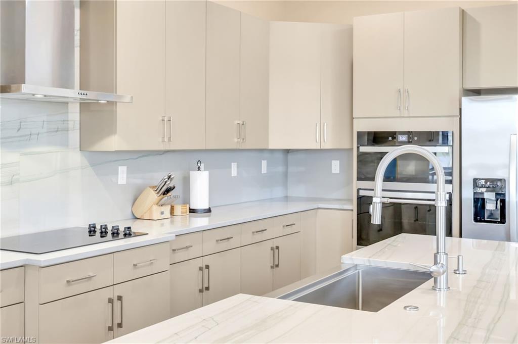 5074 Panella Avenue Immokalee, FL 34142 - Photo 8 of 48 a kitchen with granite countertop a sink stove and cabinets