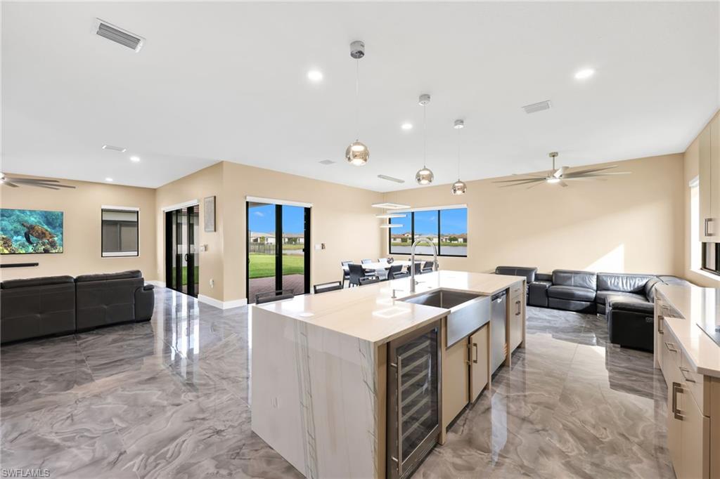 5074 Panella Avenue Immokalee, FL 34142 - Photo 10 of 48 a large white kitchen with a large window and furniture