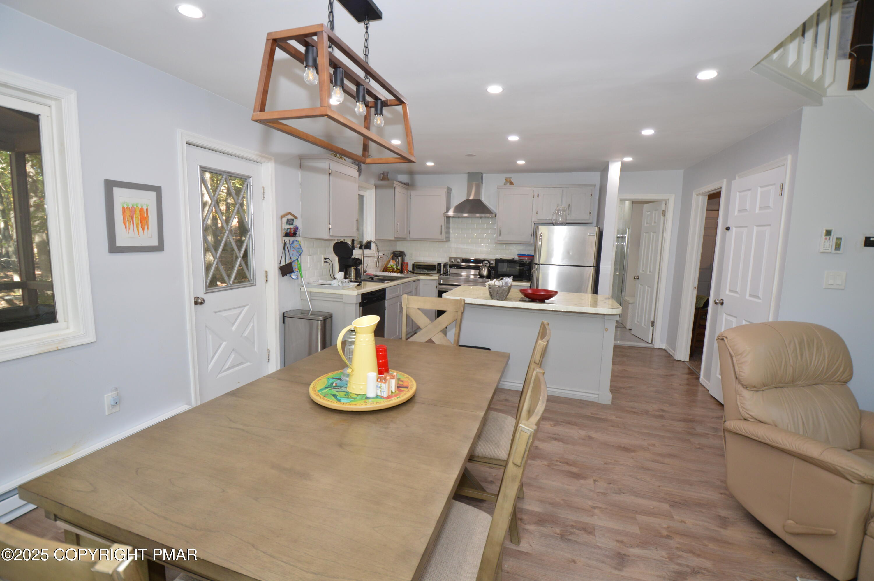 128 Ashley Court Bushkill, PA 18324 - Photo 21 of 43 a kitchen with a table chairs and white cabinets
