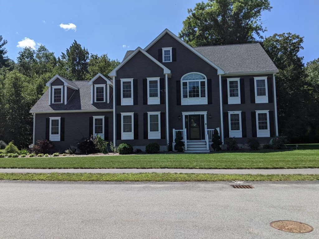 1 Quail Ridge Road Merrimac, MA 01860 - Photo 1 of 15 a front view of a house with a garden
