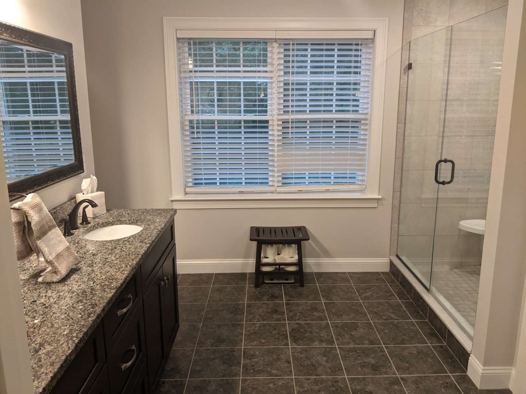 1 Quail Ridge Road Merrimac, MA 01860 - Photo 3 of 15 a bathroom with a granite countertop sink a toilet and shower
