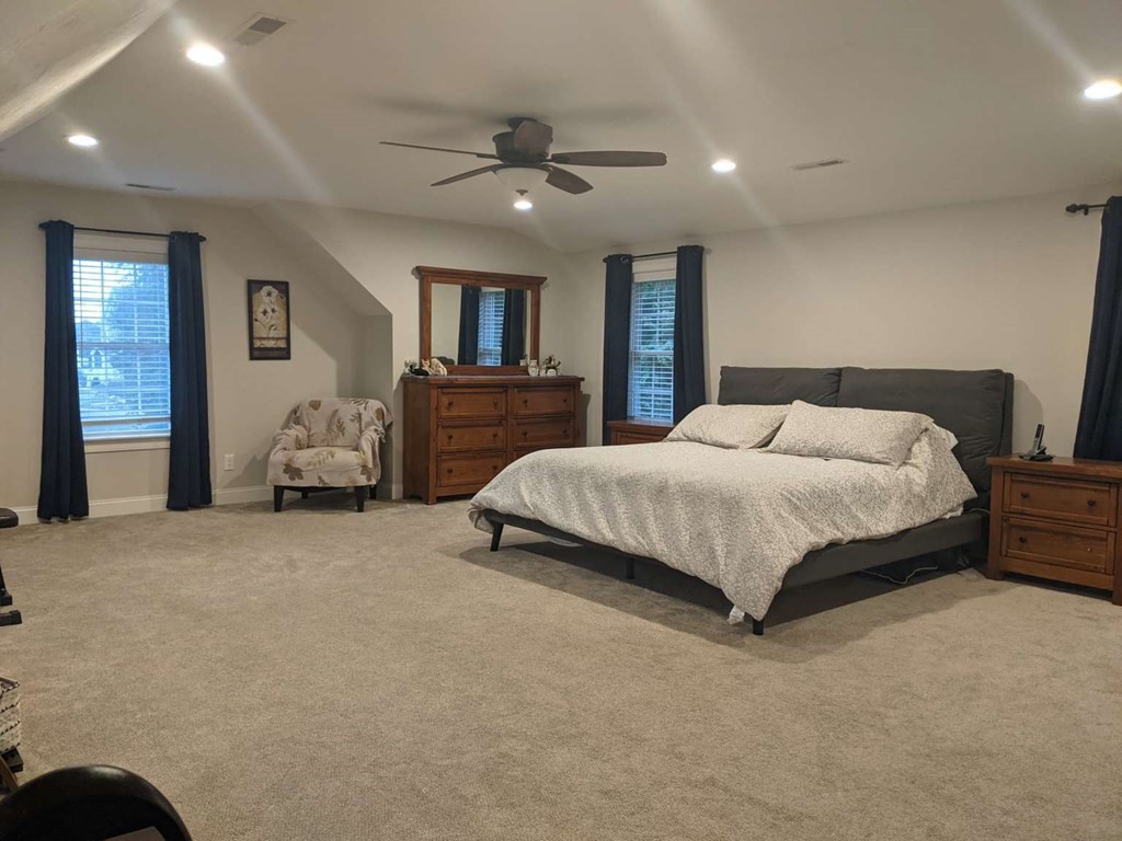 1 Quail Ridge Road Merrimac, MA 01860 - Photo 4 of 15 a bedroom with a large bed and a chandelier
