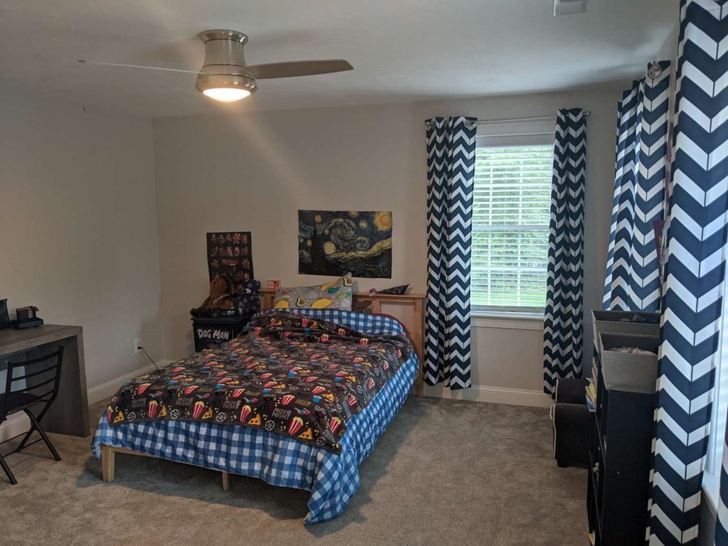 1 Quail Ridge Road Merrimac, MA 01860 - Photo 7 of 15 a bed sitting in a bedroom next to a window and a chandelier