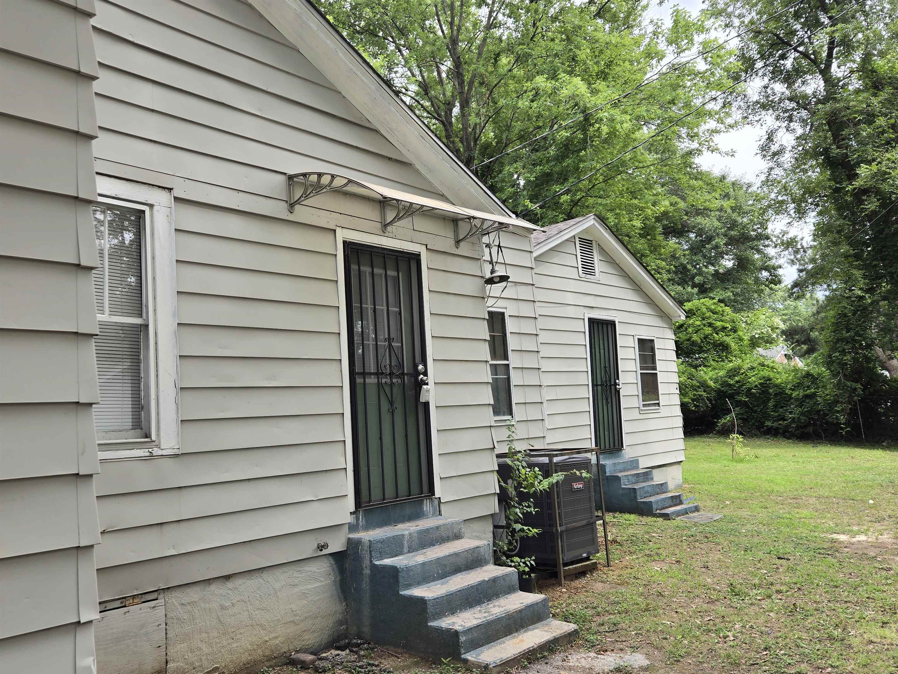 3053 Carrington Road Memphis, TN 38111 - Photo 4 of 17 View of exterior entry featuring a lawn and central AC unit