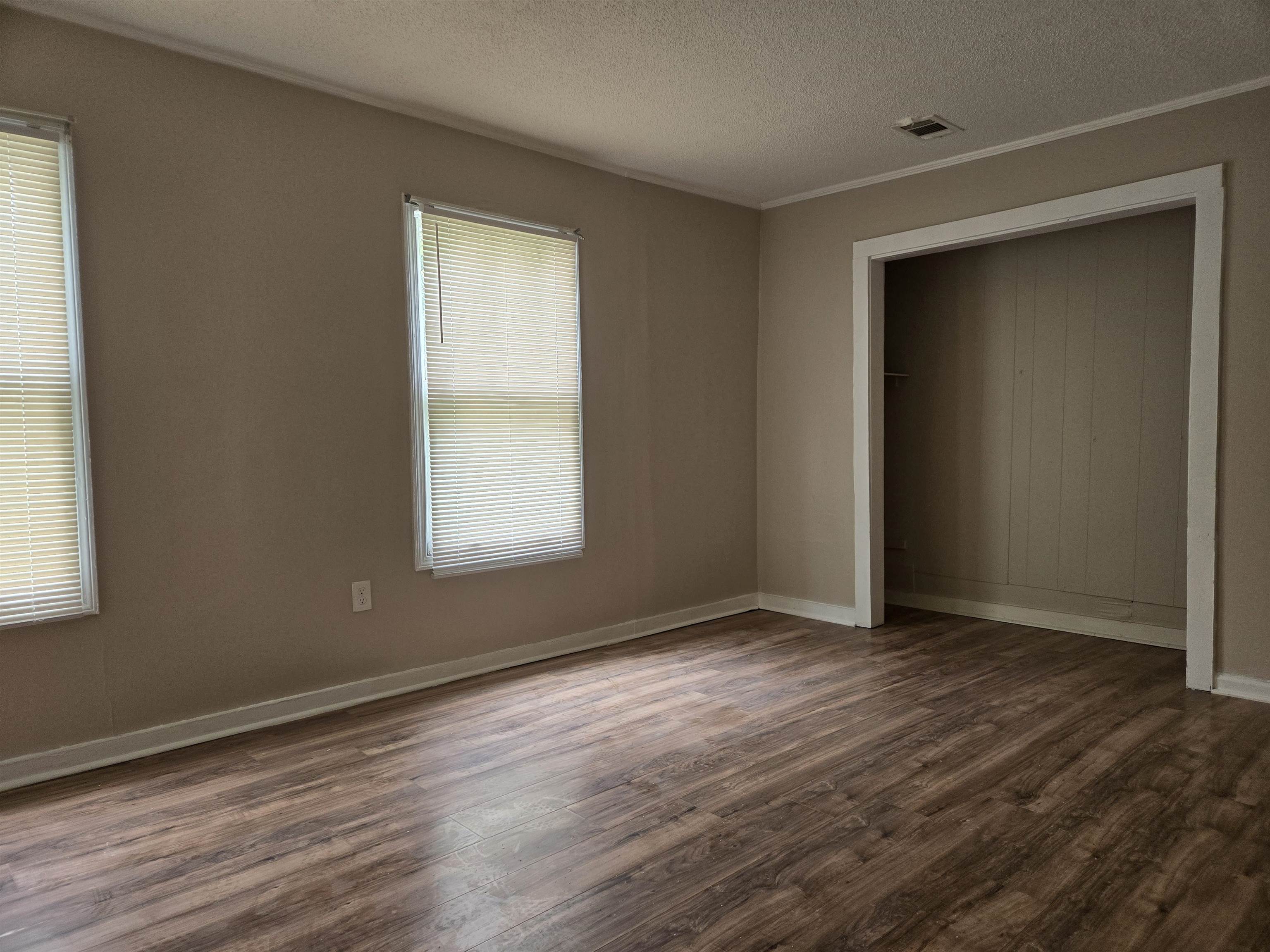 3053 Carrington Road Memphis, TN 38111 - Photo 7 of 17 Unfurnished bedroom with wood-type flooring, a closet, and a textured ceiling