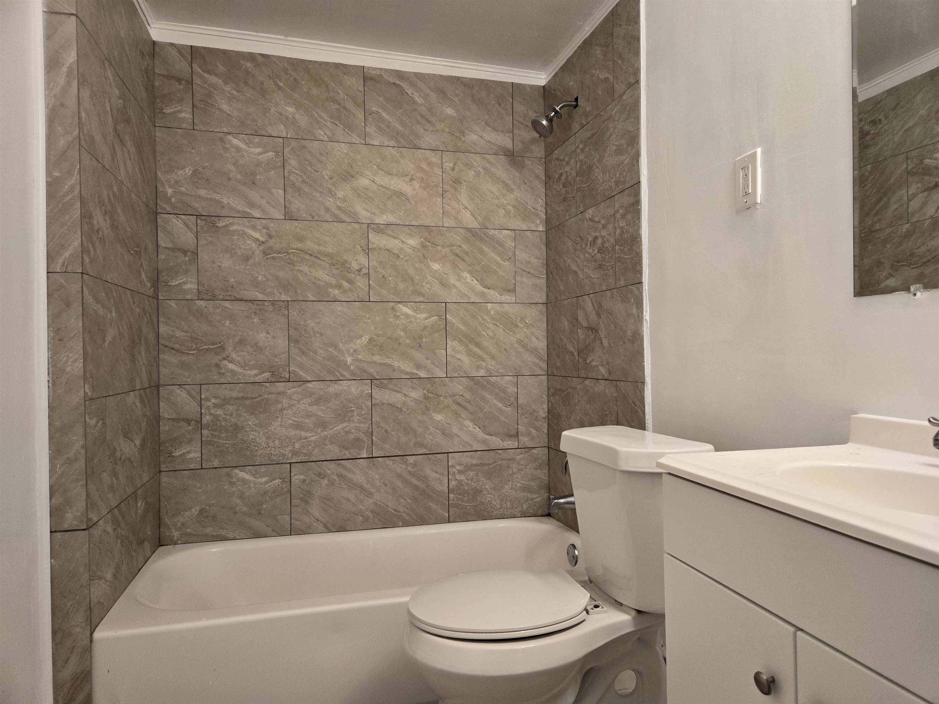 3053 Carrington Road Memphis, TN 38111 - Photo 10 of 17 Full bathroom featuring crown molding, vanity, and tiled shower / bath