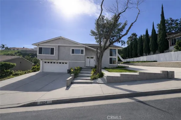 a view of house with outdoor space and trees