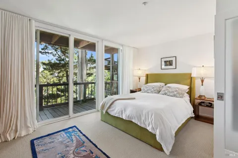 a bedroom with a bed and chair