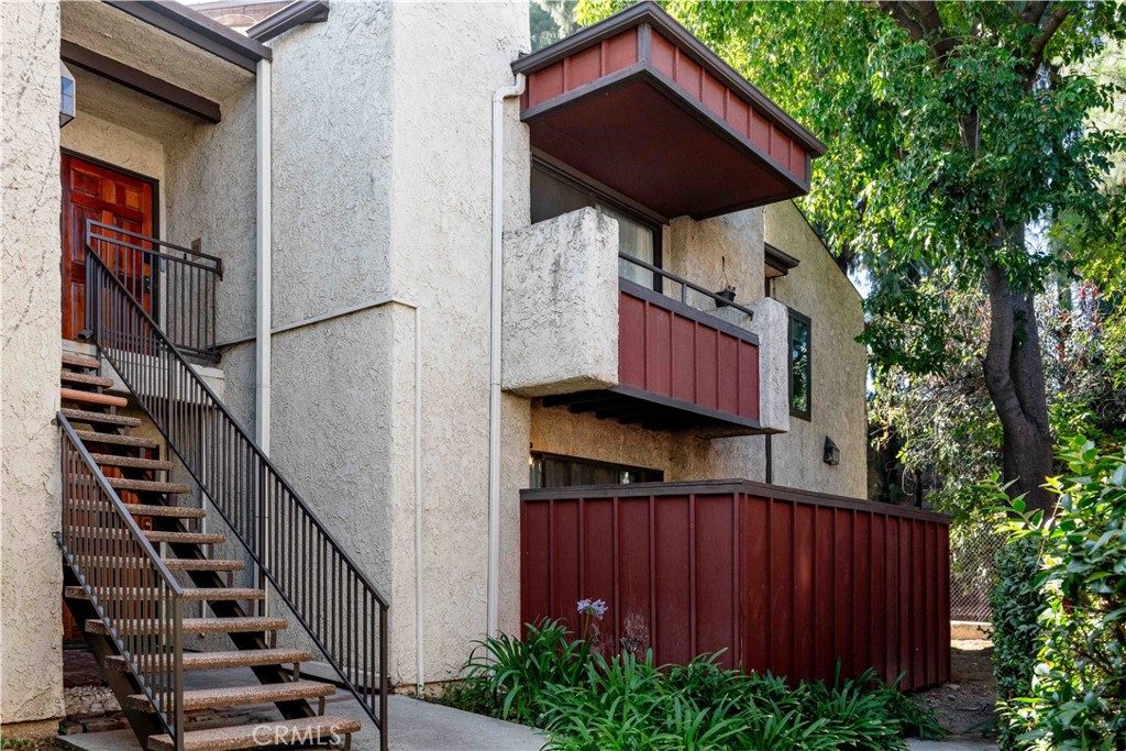 7135 Firmament Avenue, Unit 25 Van Nuys, CA 91406 - Photo 14 of 14 a view of a house with wooden fence and trees