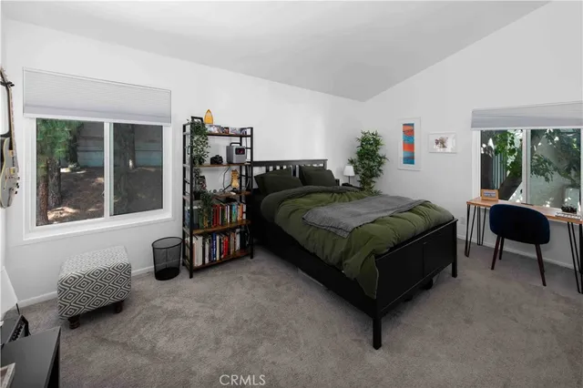 a bedroom with a bed and a large window