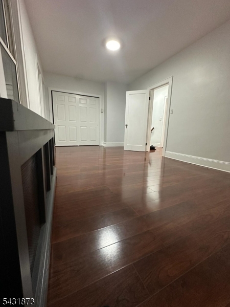 32 Hamilton Avenue, Unit 2 Fairview, NJ 07022 - Photo 16 of 30 an empty room with wooden floor and windows