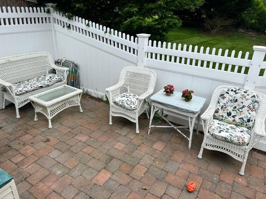 292 Route 28, Unit 1 Harwich, MA 02646 - Photo 21 of 29 a wooden bench sitting in front of a house