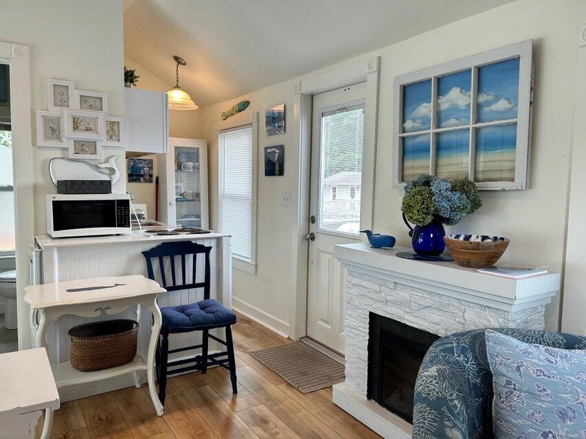 292 Route 28, Unit 1 Harwich, MA 02646 - Photo 8 of 29 a living room with furniture a fireplace and a flat screen tv