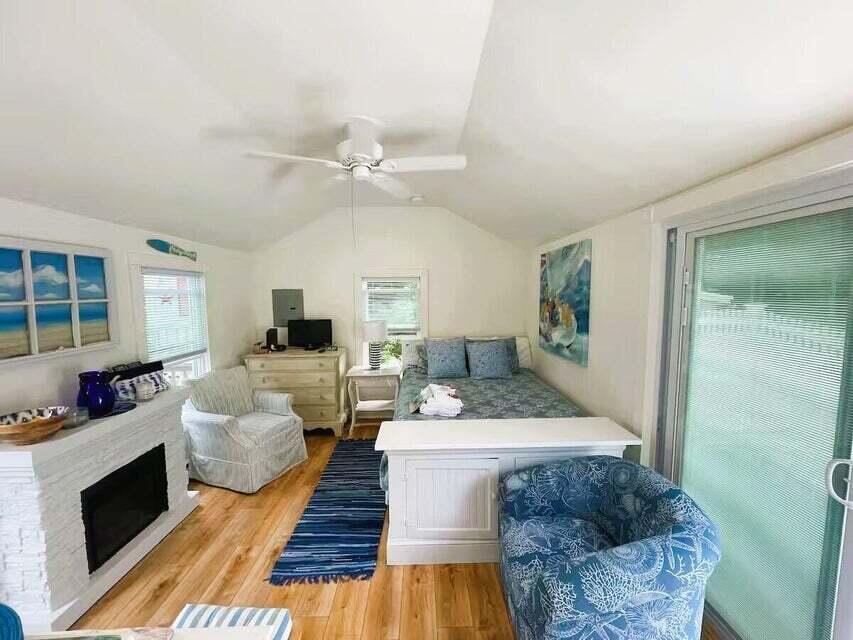 292 Route 28, Unit 1 Harwich, MA 02646 - Photo 10 of 29 a living room with furniture and a fireplace