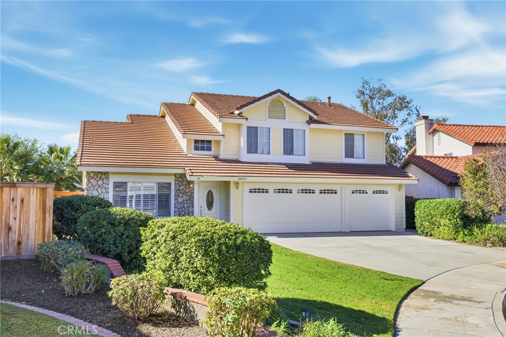 24333 Rimcrest Lane Moreno Valley, CA 92557 - Photo 3 of 62 a front view of a house with a yard and garage