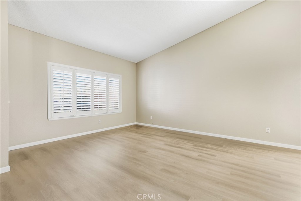 24333 Rimcrest Lane Moreno Valley, CA 92557 - Photo 9 of 62 a view of an empty room with wooden floor and a window