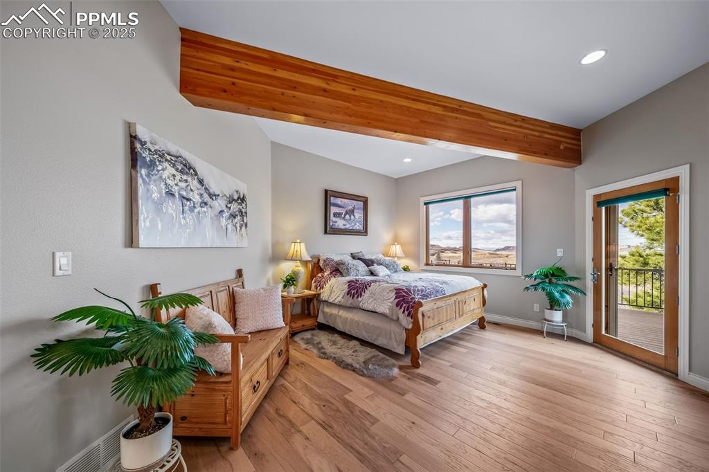 4586 East Best Road Larkspur, CO 80118 - Photo 15 of 50 Bedroom with beamed ceiling, wood-type flooring, access to exterior, and recessed lighting